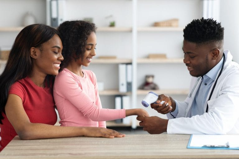 mother with child doctor appointment openimis tanzania health insurance coverage